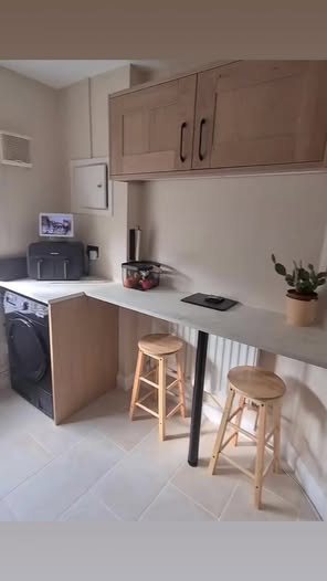 Oak shaker kitchen with a breakfast bar and two stools