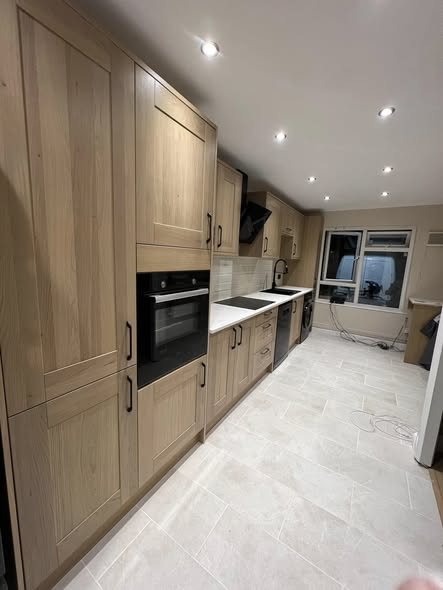 Oak shaker kitchen fitted along one wall in a Lewisham home