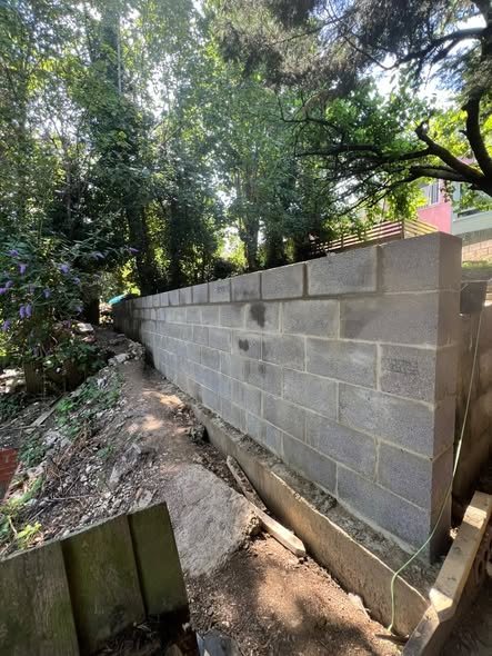 Finished block retaining wall built into a sloping garden