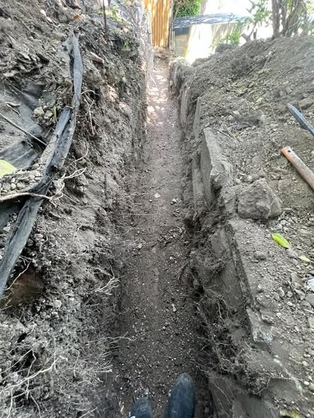 The trench dug out for the retaining wall footing before it was built